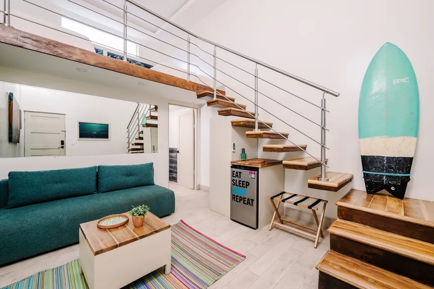 Surf Loft Suite with futon lounge and loft staircase